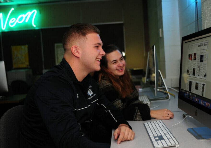 Two students looking at the computer screen