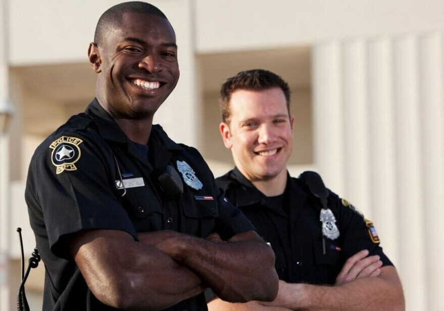 Two police officers standing with arms crossed